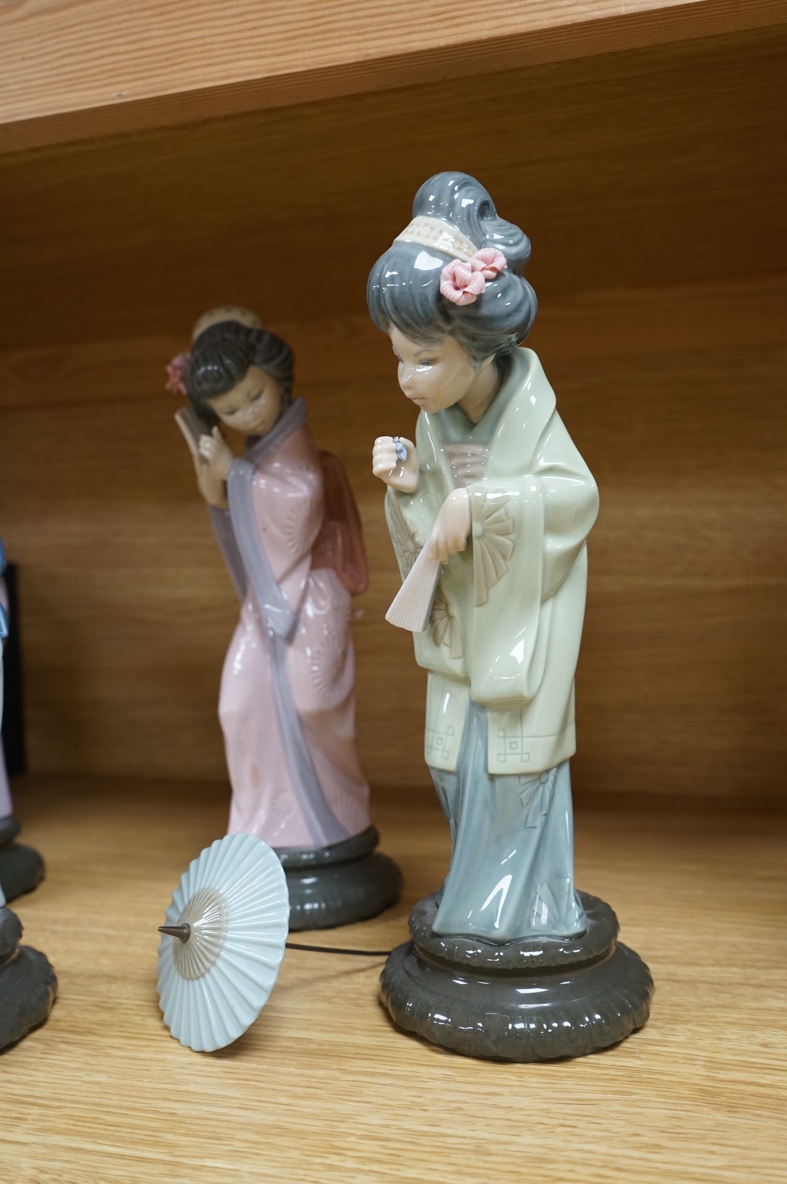 Four Lladro models of Geishas, tallest 30cm